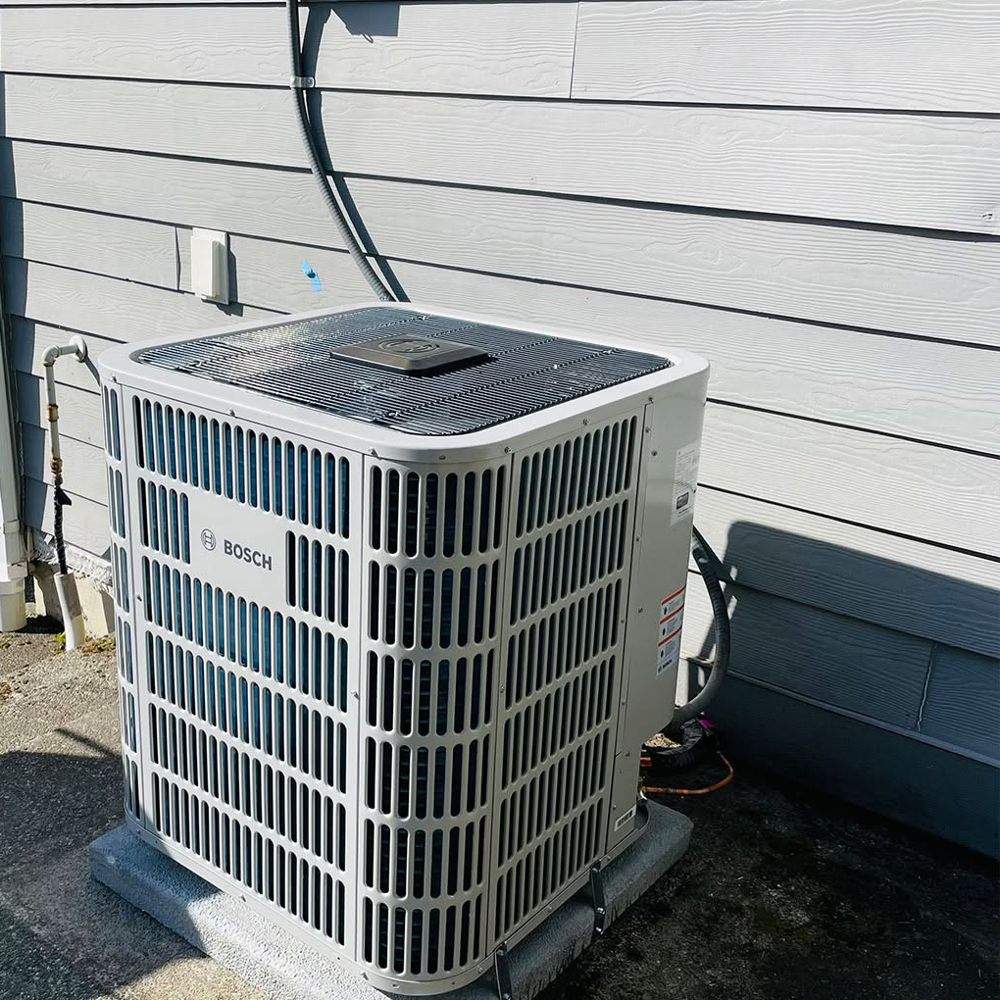 Bosch inverter heat pump installed beside gray siding