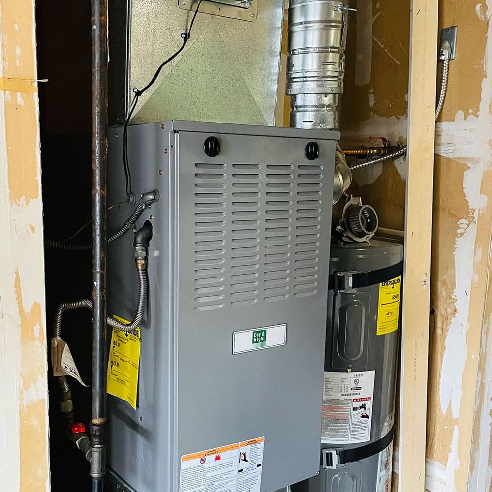 New gas furnace installed in a hallway closet