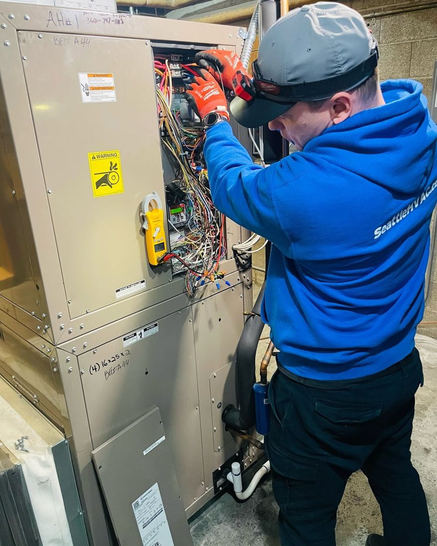 Seattle Heating & Cooling technician wiring an air handler