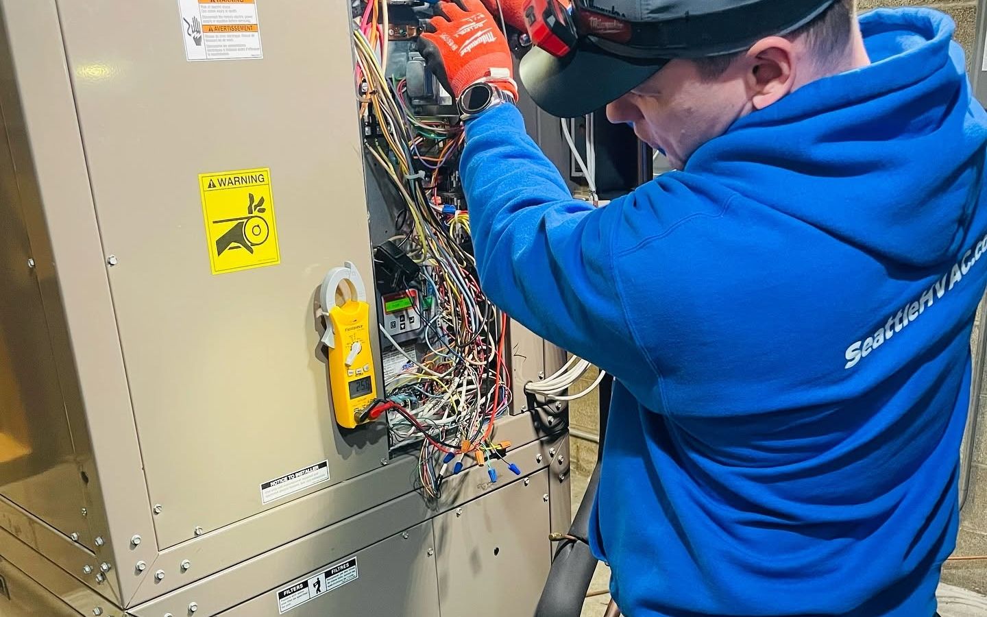 Seattle Heating & Cooling technician wiring an air handler