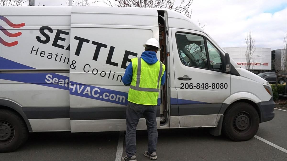 Seattle Heating & Cooling technician at a company service van